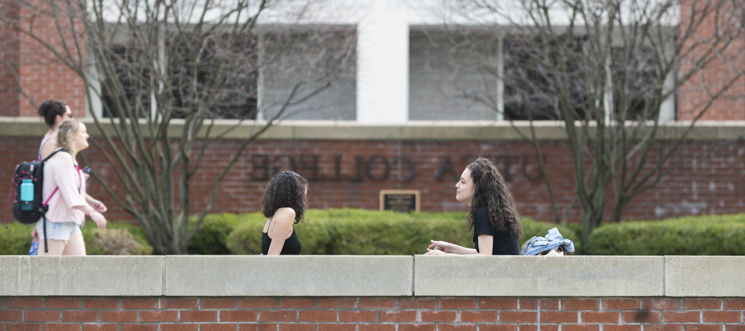 Campus Scenic - Spring - Women Sitting in front of Boehlert Hall