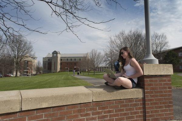 学生 sitting on campus wall in Spring 060