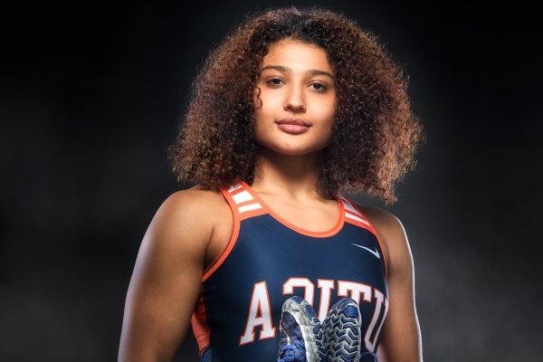 Jazmene Molina in a Utica Pioneers jersey, stands against a black background.